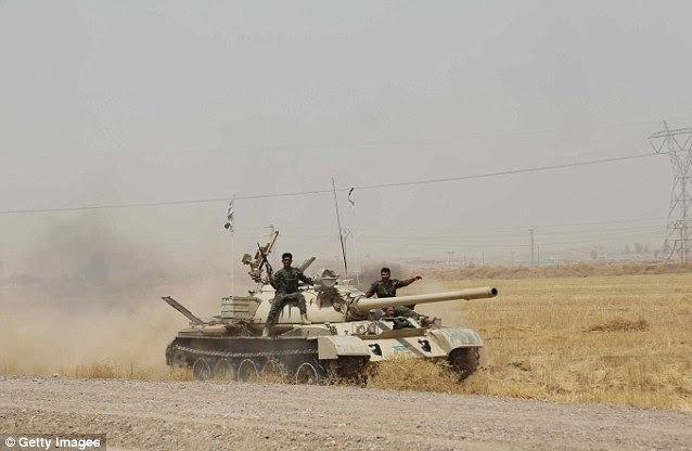 Warlike: The Kurdish Peshmerga armed forces, pictured yesterday in Kirkuk, Iraq, could defeat ISIS, but are in no mood to