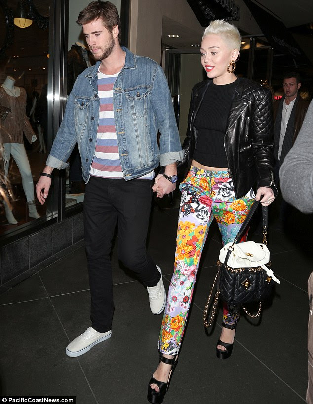 Flower power: Miley Cyrus stepped out with fiancé Liam Hemsworth to celebrate sister Noah's 13th birthday at Level 3 nightclub in Hollywood on Tuesday night