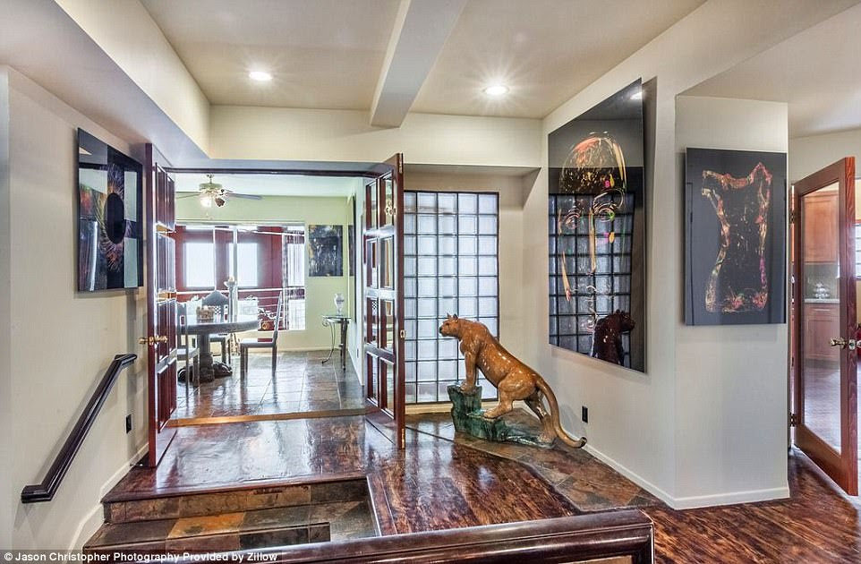 Large paintings adorn the walls to give the house a party vibe to it, while the landing is complete with a giant animal statue