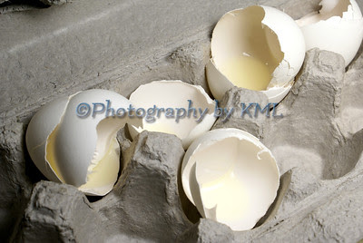 broken white eggshells in an egg crate
