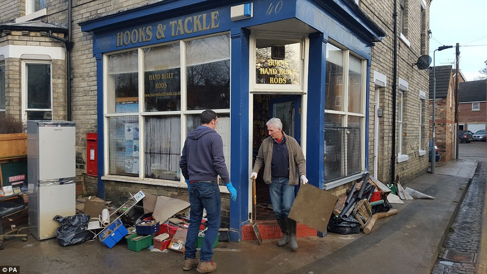 Following the floods: People clear up on Huntington Road in  York today. There is no suggestion they are connected to looting on the road