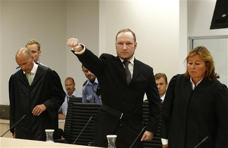 Norwegian mass killer Anders Behring Breivik (C) gestures as he arrives in the court room at Oslo Courthouse August 24, 2012. The Norwegian court delivers its verdict in the ten-week trial of gunman Breivik on Friday, deciding whether to send the anti-Muslim militant to jail or a mental hospital for the massacre of 77 people last summer. REUTERS/Heiko Junge/NTB Scanpix/Pool