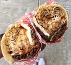 [I Ate] Lumpia, Fries, sisig, spam, and fried egg stuffed burrito ....