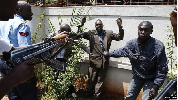 Policemen search a man for weapons as he walks out of Westgate Shopping Centre in Nairobi