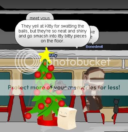 Kitty goes after shiny Christmas balls