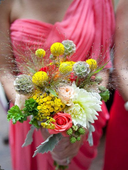 bouquet made of dahlias, coral moscow roses, scabiosa pods, billy balls, yellow feverfew, fillament grass, and geranium.  Wildflower look