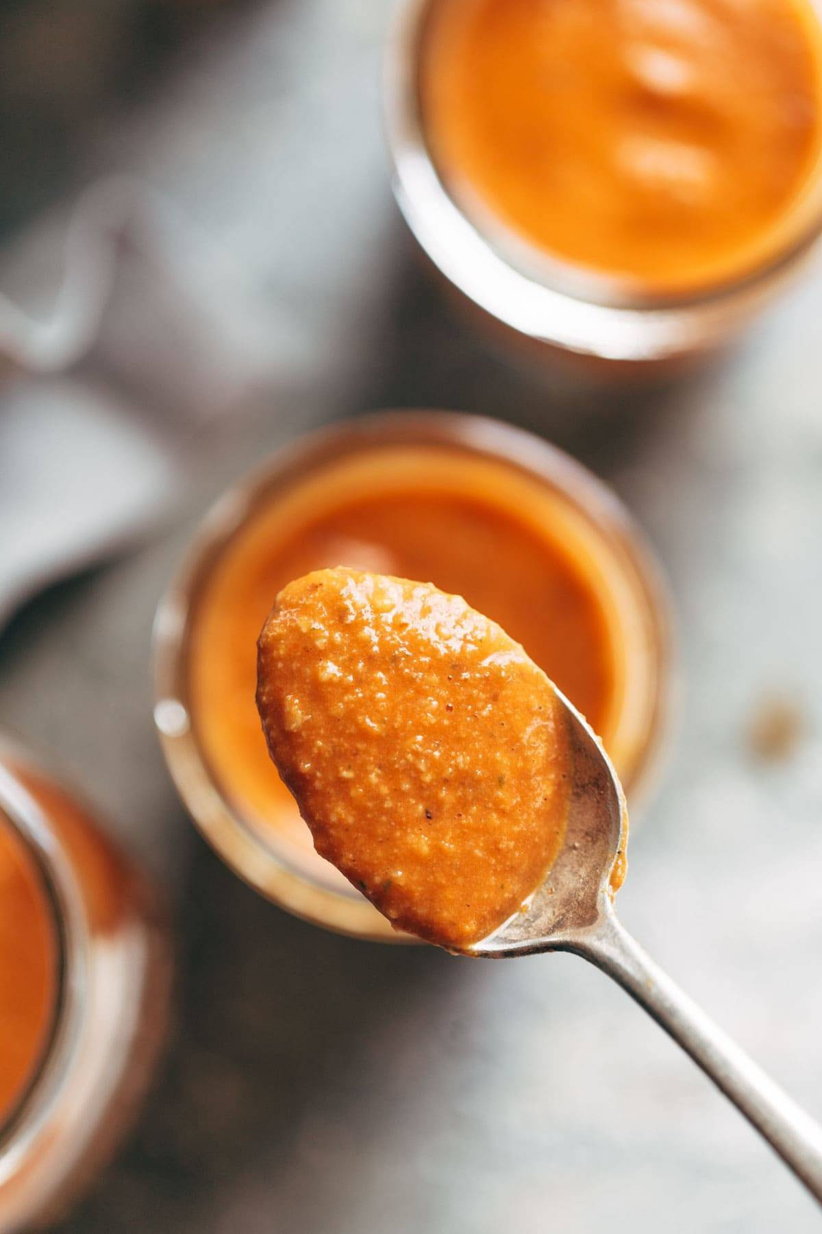 Romesco Sauce! ready in 5 minutes and perfect for serving with grilled chicken, vegetables, crispy potatoes, eggs, and more. Made with roasted red peppers, tomatoes, olive oil, garlic, salt, parsley. vegan / vegetarian. | pinchofyum.com 