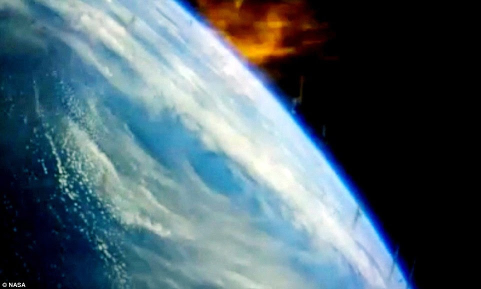 Looking home: Cameras onboard the Orion capsule took this stunning snap of the Earth during re-entry. Flames show the incredible heat the capsule was subjected to, as it hit speeds of 20,000 mph and weathered temperatures approaching 2,200°C (4,000°F)