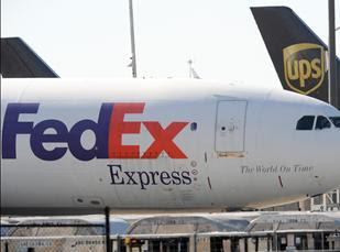FedEx and UPS cargo planes sit on the tarmac of the north cargo terminal area in Atlanta on Oct. 30. The glaring weakness of the cargo shipping system has been laid bare by the Yemen-based mail bomb plot. But the cost of fixing it may be too high for governments, airlines and shippers to stomach during a global downturn. 