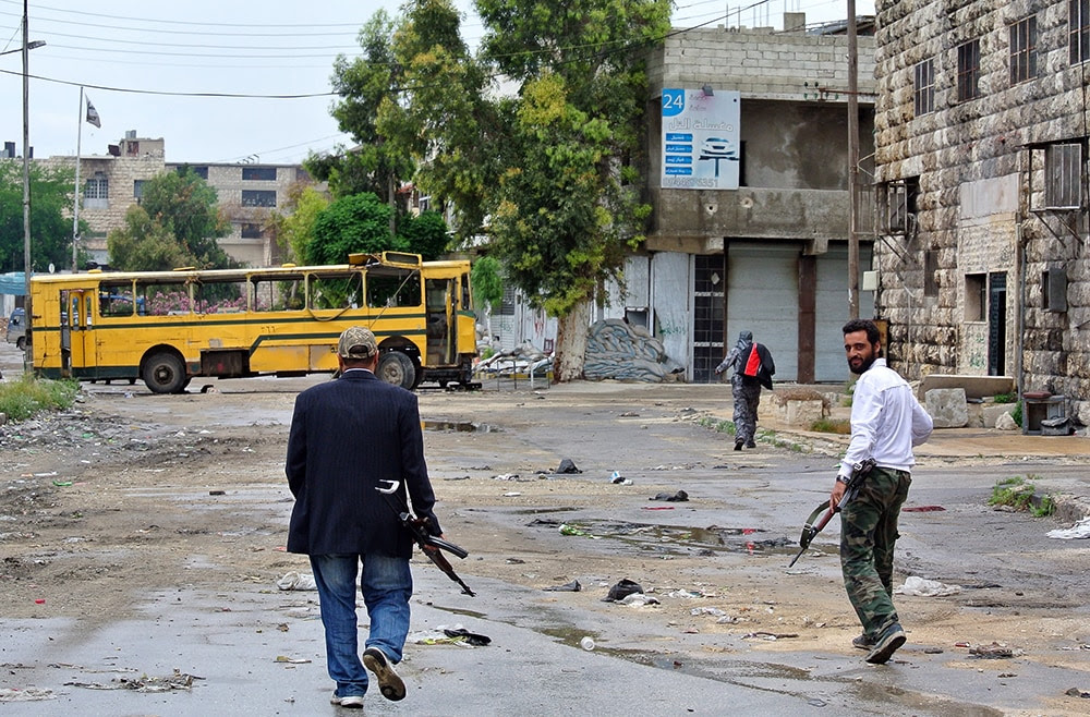Rebel fighters walk through Aleppo. (AFP/Getty Images)