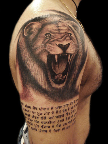  Lion whit punjabi writing tattoo 
