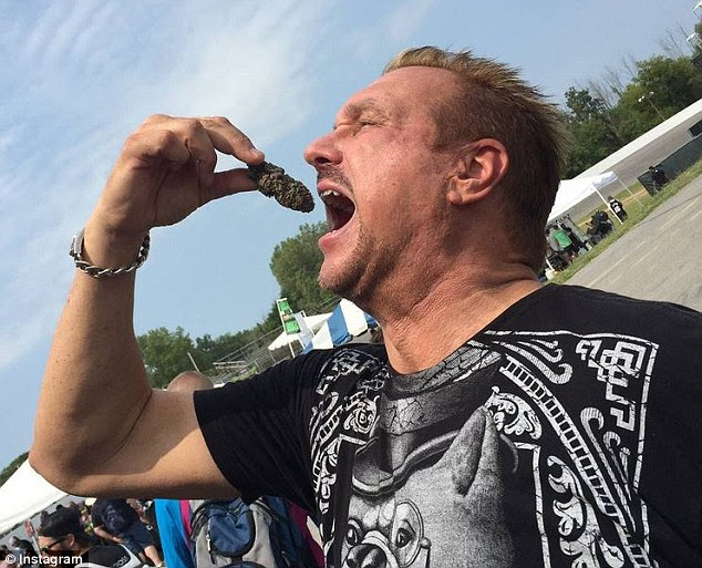 Big Mike lowers a cannabis 'bud' towards his mouth. As state relax marijuana legislation, more people are flaunting their use and manufacture on social media 