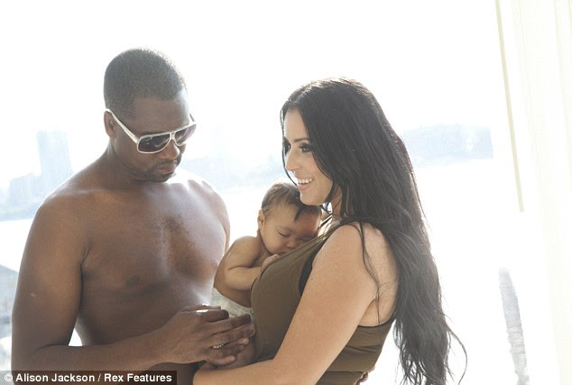 At ease: The images show Kim looking very happy in her new role as a mother