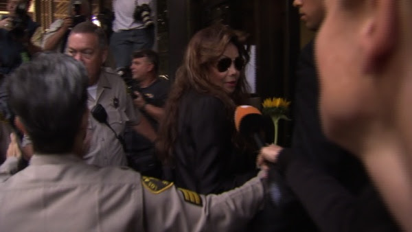 Holding a sunflower given her by a fan, Michael Jackson's sister Latoya Jackson arrives at the involuntary manslaughter trial for Dr. Conrad Murray on Tuesday, Sept. 27, 2011.