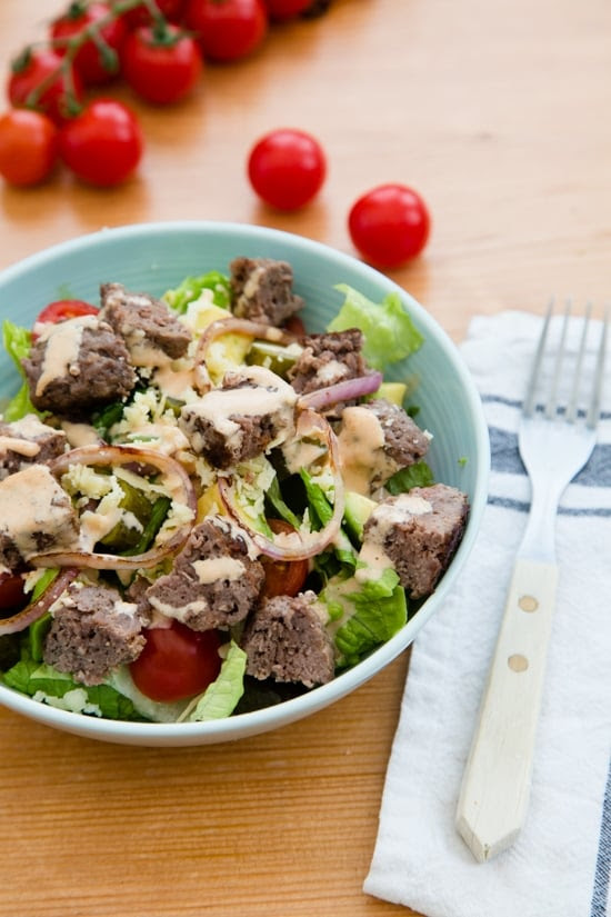 This salad has everything I love about a cheeseburger, sans the bun. Chopped romaine, tomatoes, avocado, pickles and shredded cheese are topped with grilled burgers and red onions and drizzled with a seriously delicious dressing.