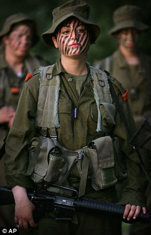 An Israeli woman soldier prepares for a military training session near Jerusalem