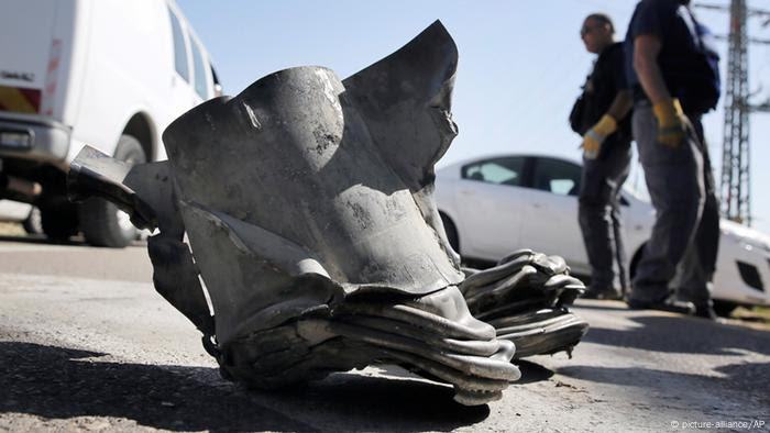 Israeli explosives experts stand by an rocket fired from the northern Gaza Strip that landed near the costal city of Ashkelon, Tuesday, Feb. 26, 2013. It was the first such projectile from the Palestinian territory to hit Israel since Israel-Gaza hostilities last November. The rocket fire came one day after Israeli troops injured two Palestinian teenagers near a holy site close to Bethlehem, during one of the many demonstrations Palestinians in the West Bank have staged in recent days. (AP Photo/Tsafrir Abayov)