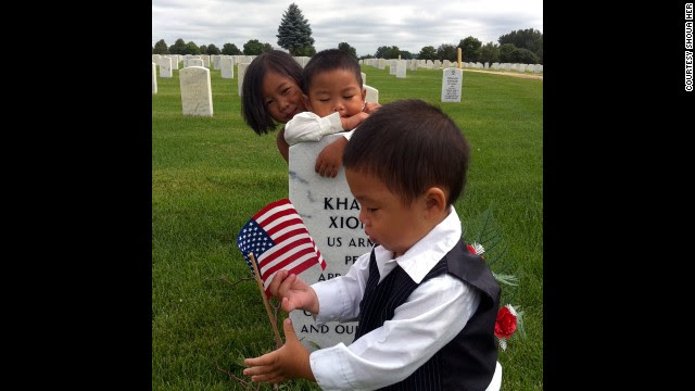 Kham Xiong's children visit their father's grave at Fort Snelling National Cemetery in Minnesota. Xiong was one of the 13 people killed in the Fort Hood shootings in 2009.