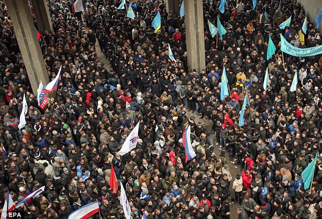 Clash: Pro-Russian protesters (left) stand opposite Crimean Tartars, who support the new regime in Ukraine