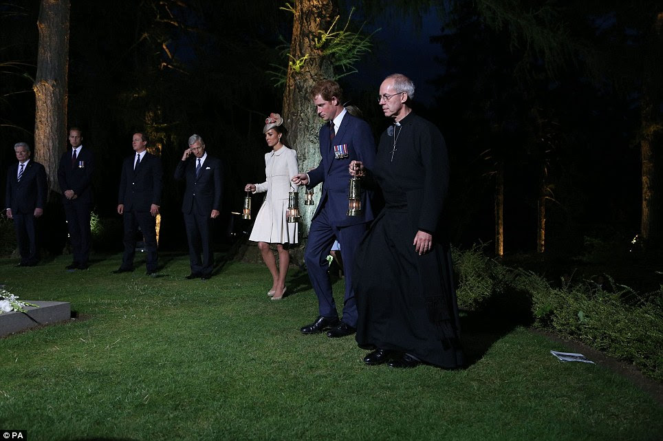 Holding lanterns: The Duchess of Cambridge, Prince Harry and The Most Revd and Rt Hon Justin Welby at a ceremony at St Symphorien Cemetery at Mons, Belgium