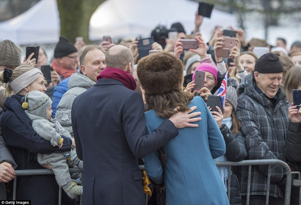 The couple pose for a photo for well-wishers, many of whom snapped pictures and waved Union flags. They were also given gifts including books, knitwear and flowers by enthusiastic fans lining the railings outside Oslo's Royal Palace