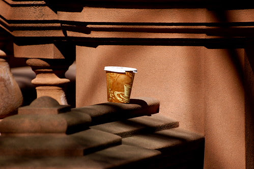 Coffee left on a brownstone railing