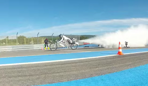 Francois Gissy rides his rocket-powered bike
