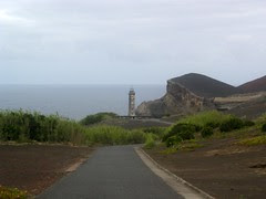 An old lighthouse not more in use because of the recent volcano outbreak making a new island in front of it