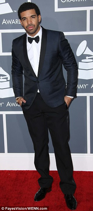Taking it to court: Chris Brown, left, and Drake, right, both arriving at Sunday night's Grammy Awards, are believed to be suing each other over their New York City nightclub brawl 