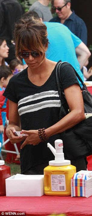 Treat yourself: Halle was loading up on napkins and sauces as she purchases some hotdogs