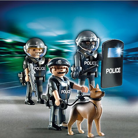 Playmobil's "City Action" series features cops in riot gear with shields and gas masks holding big guns, clubs and dogs ready to bite the face off of protestors. All part of the agenda of normalizing a violent, oppressive police state. 