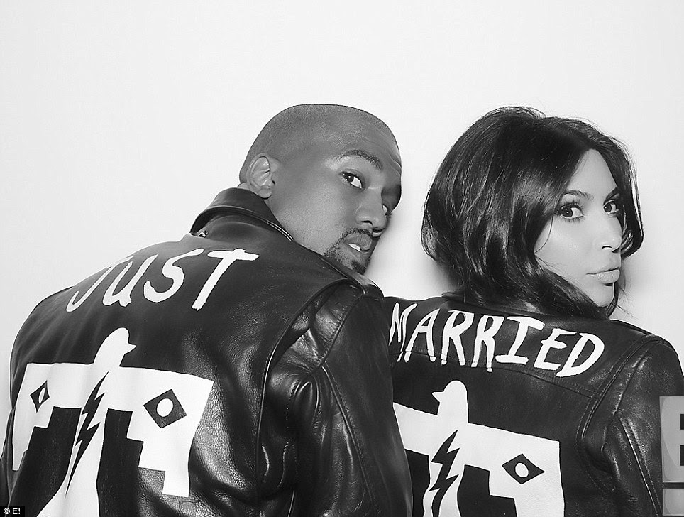 Happy couple: This previously unseen wedding booth photo shows Kim and Kanye wearing matching leather jackets at the opulent ceremony in Italy