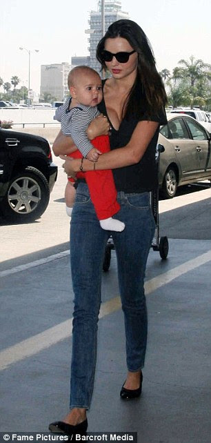 Shared parenting: Miranda, who welcomed Flynn in January, says she and Orlando share duties equally - 'whoever has their hands free'