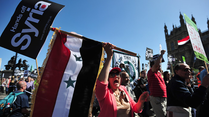 Protesters shout slogans and wave the Syrian flag as they demonstrate against military intervention in Syria in central London on August 31, 2013 (AFP Photo / Carl Court)