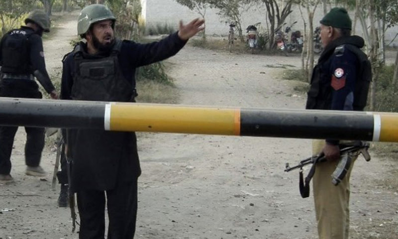 This picture shows security personnel standing on alert at a street in Hangu. — File photo/Online
