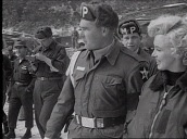 Military Police escort Marilyn Monroe through US army base, Korea; Feb 54