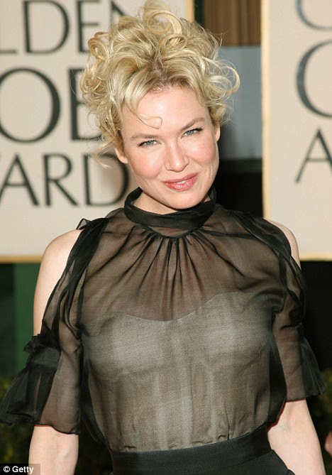 What's that under there? Renee Zellweger teams a transparent net dress with a very visible white basque at the 66th Annual Golden Globe Awards in Beverly Hills