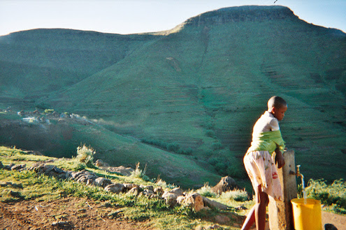girl collect water on mountain