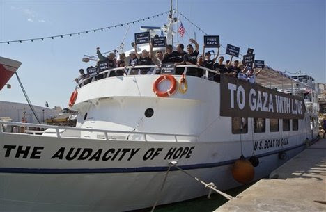 Activists from the U.S. stand on their boat named "The Audacity of Hope" moored in Perama, near Athens, Greece, Thursday, June 30, 2011.