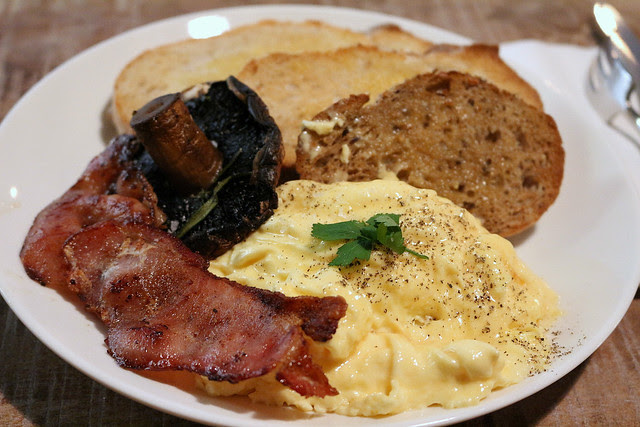 Breakfast: scrambled eggs with bacon and portobello mushroom