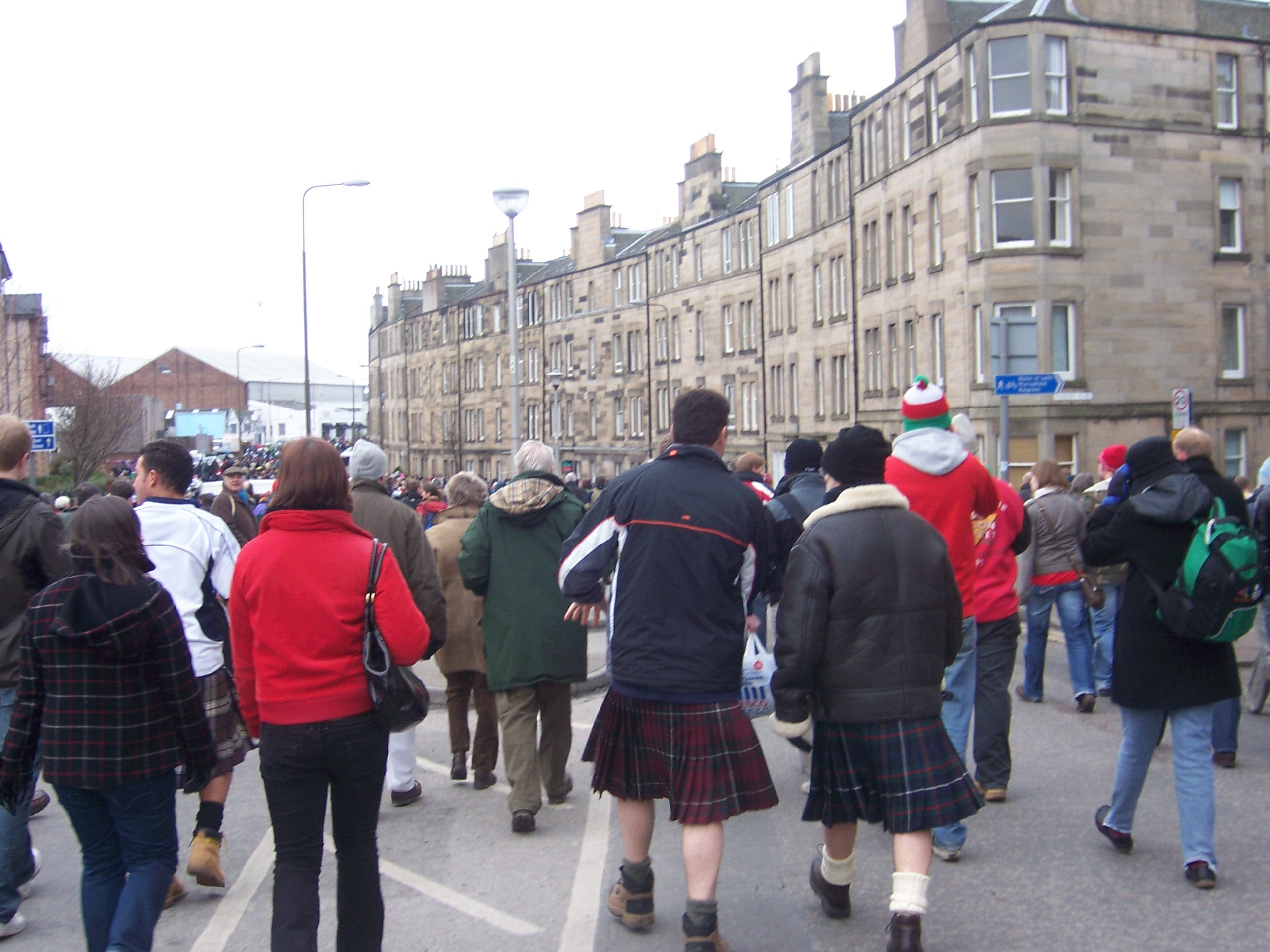 Kilted men on the way to the stadium.