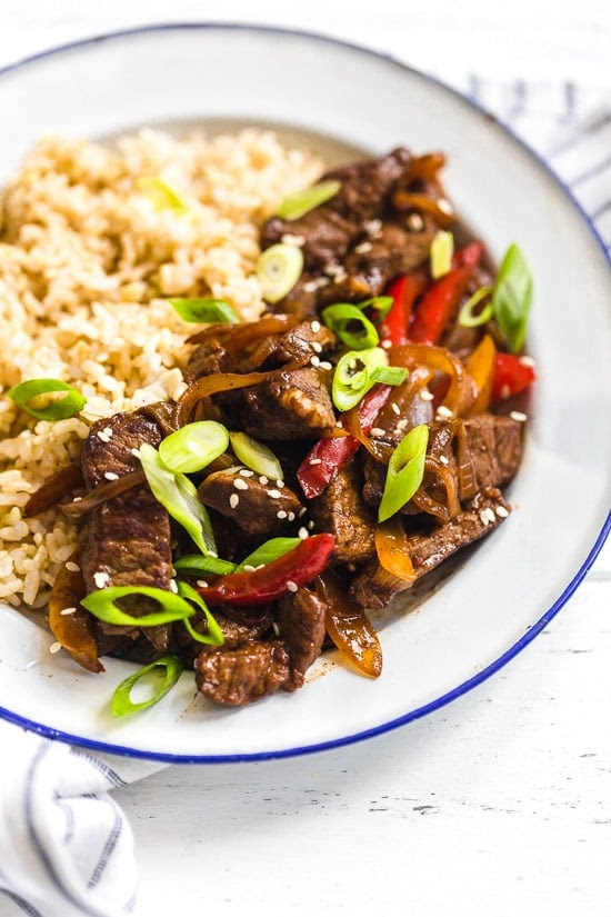Pepper steak is quick, easy and perfect to whip up any night of the week. Strips of beef and bell peppers are stir fried in a wok to create a delicious main dish, ready in no time! I love it with brown rice, but cauliflower rice would also be great on the side.