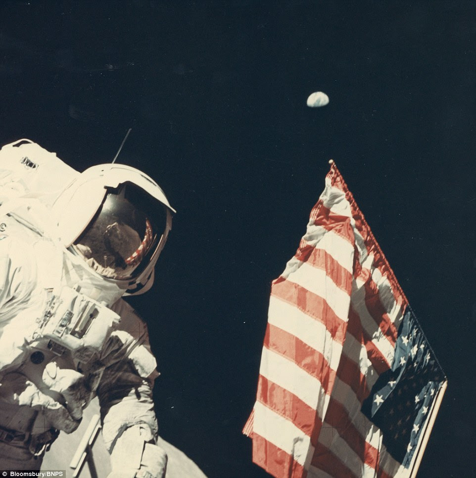 Valued at £1,000, this image, taken by astronaut Eugene Cernan, shows Harrison 'Jack' Schmitt with Earth above the US flag, during the Apollo 17 mission in December 1972