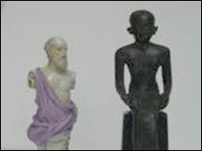 A bronze statue of Imhotep next to a porcelain figure of Hippocrates