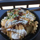 [I Ate] Irish Nachos. Cheese Sauce, Smoked Bacon, Sour Cream, Chives