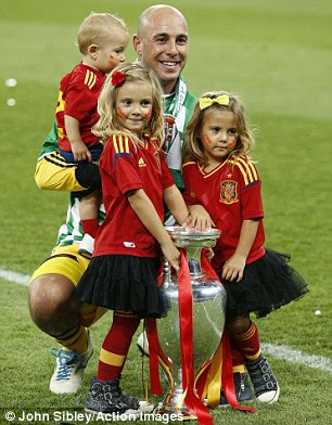 Family memories: Goalkeeper Reina, 29, is joined by his young family, while right, Torres lets his little ones enjoy a mini pitch invasion