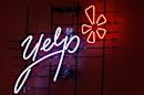 FILE - This Oct. 26, 2011 file photo shows the logo of the online reviews website Yelp on a wall at the company's offices in New York. Yelp on Tuesday, Feb. 10, 2015 said it bought online food delivery service Eat24 for $134 million. (AP Photo/Kathy Willens, File)