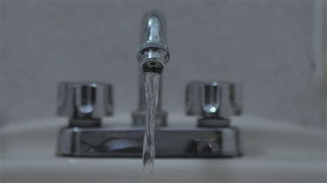 Stay hydrated and healthy with these 8 ways to drink more water. Water coming out of a tap in a sink - Free Stock Video