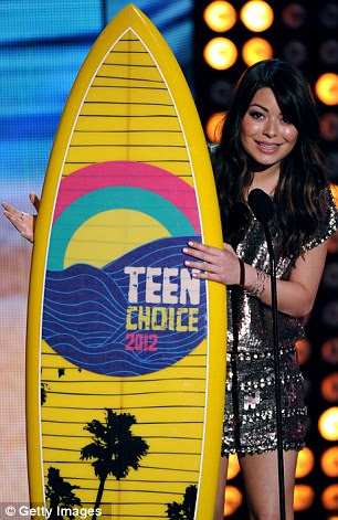 Surf's up: Miranda Cosgrove accepts the TV Comedy Actress Award, while Jonah Hill acknowledges the Choice movie award for his hit film 21 Jump Street 