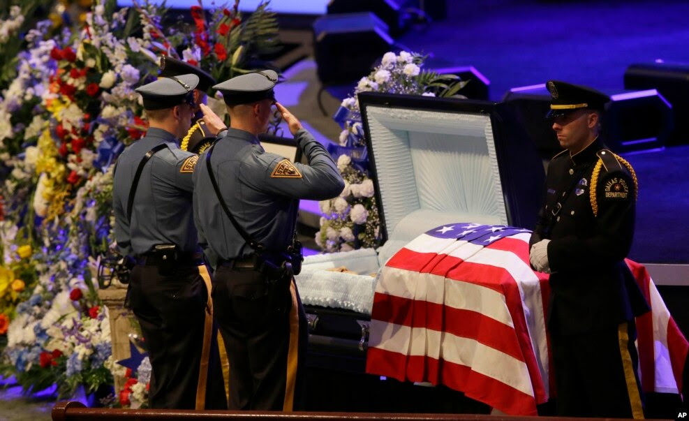 FILE - Law enforcement officer salute Dallas Police Sr. Cpl. Lorne Ahrens before his funeral service at Prestonwood Baptist Church in Plano, Texas, July 13, 2016.